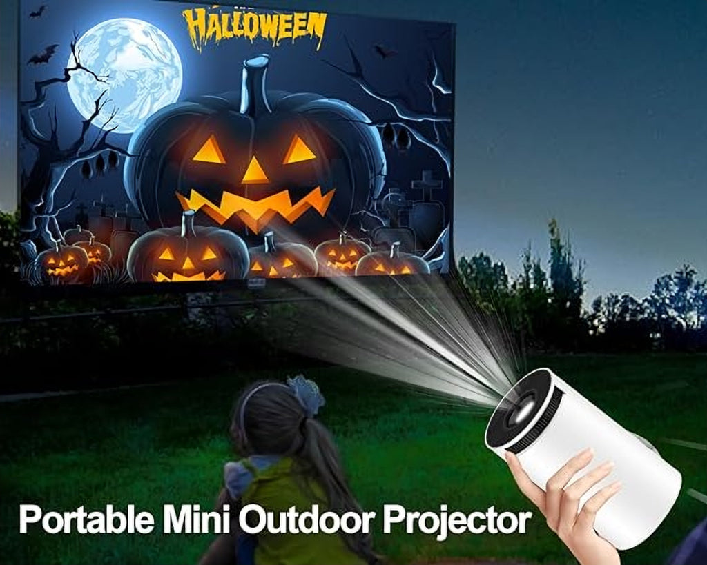 Portable mini projector used outdoors to project a movie at night